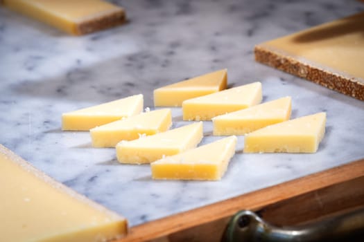 funny tasted pieces of cheese for lunch or apperitive on a marble table