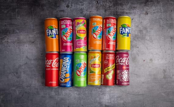 december 21 2022 : Lyon, Rhone Alpes Auvergne, France : groups of cans of sweetened sodas. Famous brands on a background of material