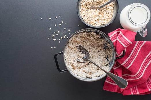 Oatmeal bowl. Cooked oatmeal served with fresh milk. Healthy food, diet. Top view.