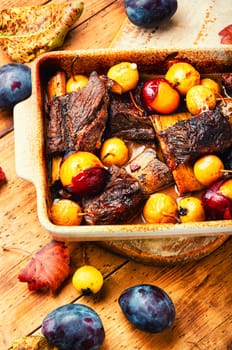 Lamb ribs baked with pear and plum.