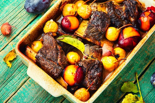Lamb ribs baked with pear and plum.