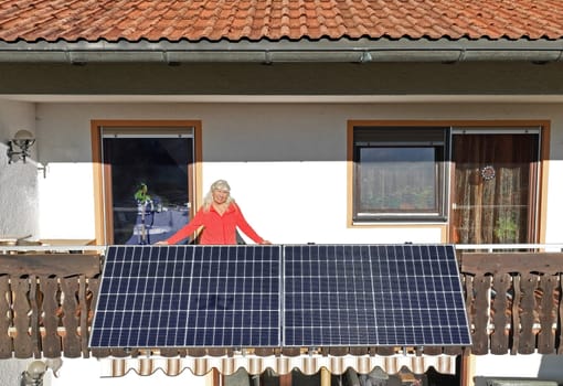 A woman is happy about the new balcony power plant