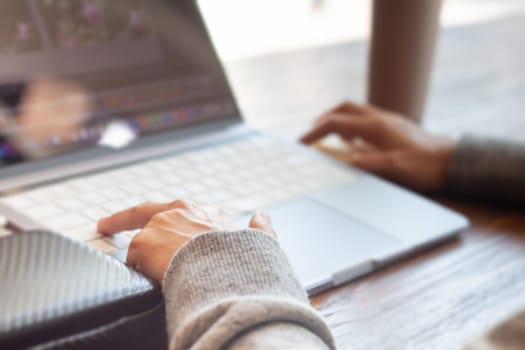 Woman working with a laptop, stock photo