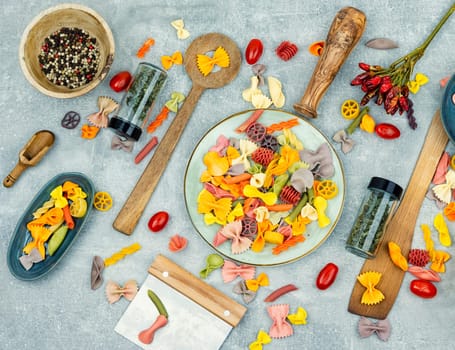 Colorful italian raw pasta on plate. Different types of Italian pasta