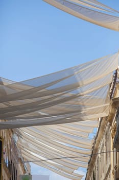 Large awnings over Cordoba downtown, Spain. Pedestrian main street, covered with sun shades