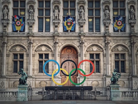 Close up Paris City Hall entrance. Outdoors view to the beautiful ornate facade of the historical building and the olympic games rings symbol in front of the central doors, as France host in 2024