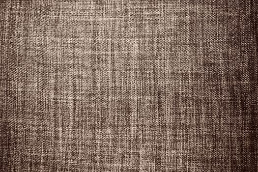brown background fabric texture. A piece of woolen cloth is neatly laid out on the surface. Weave and textile texture. Dress fabric or for kitchen needs, tablecloth or curtains, close-up. Dash.