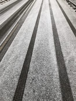 white snowy road with car tracks