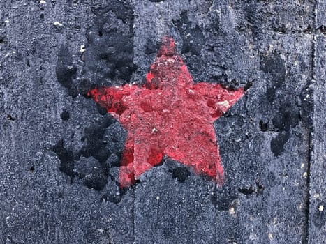 red five-pointed star on a black shabby background