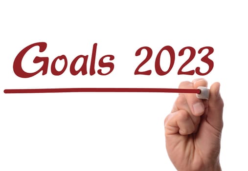 Hand writing with red pen year number 2023 on glass, business concept