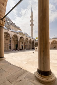 Istanbul, Turkey - August 26, 2022: Courtyard of Suleymaniye Mosque with few tourists walking around, an Ottoman imperial mosque located on the Third Hill of Istanbul