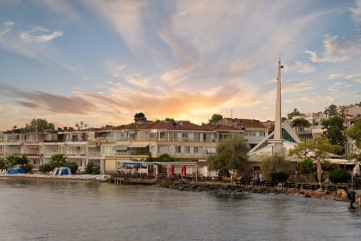 View of the mountains of Kinaliada island from Marmara Sea, with traditional summer houses and modern architecture mosque, Istanbul, Turkey