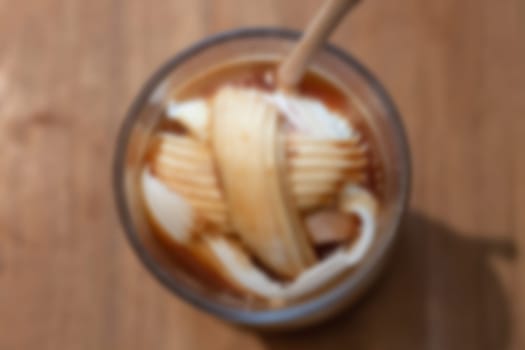 Glass of americano mixed with coconut blur background, stock photo