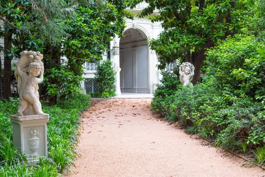 Milan, Italy - Circa June 2021: Italian Villa entrance with garden. Luxurious green exterior