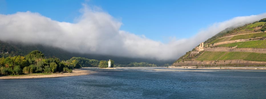 BINGEN, GERMANY - OCTOBER 8, 2021: Mouse tower within the Rhine river against dramatic clouds on October 8, 2021 in Bingen, Rhine valley, Germany