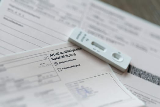 Certificate after a positive Corona test for the employer with the german inscription Arbeitsunfaehigkeitsbescheinigung. Translation: certificate of incapacity for work