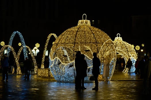 Christmas decoration with visitors on the cathedral square in Magdeburg between Christmas time and the turn of the year