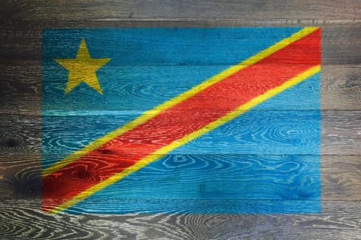 A Democratic Republic of Congo flag on rustic old wood surface background