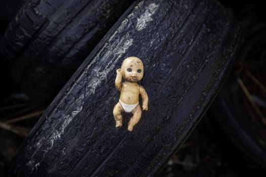 Detail of old and dirty toy in the trash