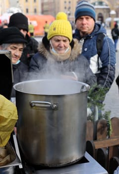Krakow, Poland - Dec 18, 2022: Christmas Eve for poor and homeless on the Main Square in Cracow. The group Kosciuszko prepares the greatest eve in the open air in Krakow
