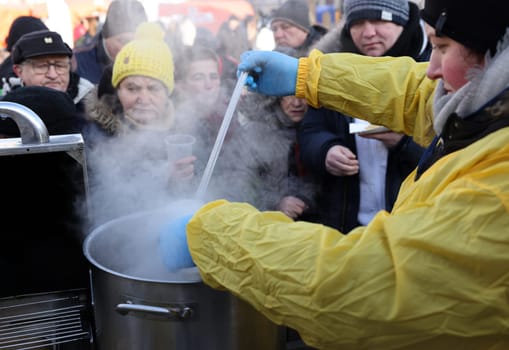 Krakow, Poland - Dec 18, 2022: Christmas Eve for poor and homeless on the Main Square in Cracow. The group Kosciuszko prepares the greatest eve in the open air in Krakow