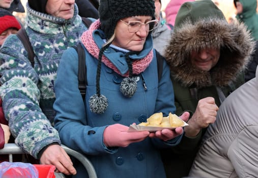 Krakow, Poland - Dec 18, 2022: Christmas Eve for poor and homeless on the Main Square in Cracow. The group Kosciuszko prepares the greatest eve in the open air in Krakow