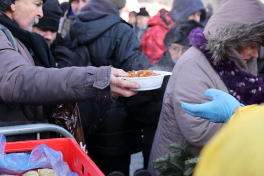 Krakow, Poland - Dec 18, 2022: Christmas Eve for poor and homeless on the Main Square in Cracow. The group Kosciuszko prepares the greatest eve in the open air in Krakow