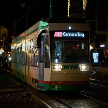 Tram of the Magdeburger Verkehrsbetriebe, MVB, at a stop in the city center of Magdeburg in the late evening