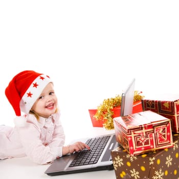 cute little girl buying christmas gifts on the internet