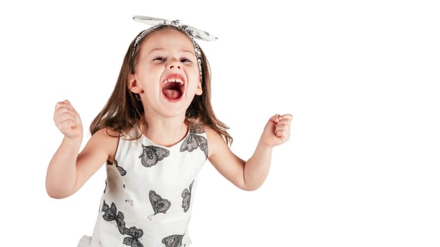 Crazy little girl loudly scream clenching fists. Portrait of child isolated on white. Emotional facial expression, splash out feelings. Saint Valentine's Day concept, holiday of all lovers.