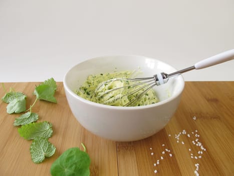 Preparation of herb butter in a bowl