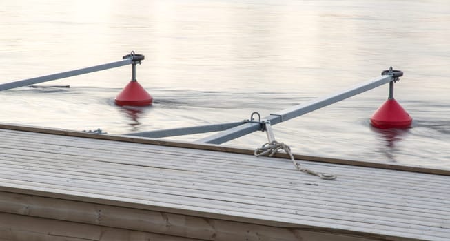 Small Boat Marina in River with orange buoys.