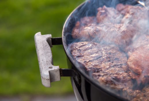 Meat on the Barbeque smoking.