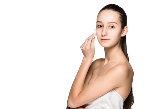 skin care woman removing face with cotton swab pad - skin care concept. Facial closeup of beautiful Caucasian model with perfect skin. Girl isolated on white background