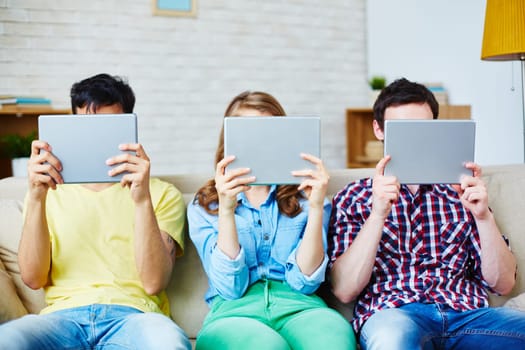 Group of teenagers spending leisure with touchpads
