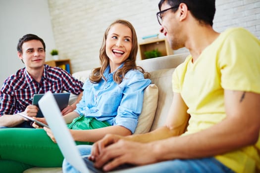 Modern teenagers with touchpads and laptop communicating at leisure