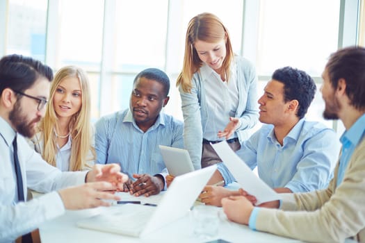 Group of successful professionals communicating in office