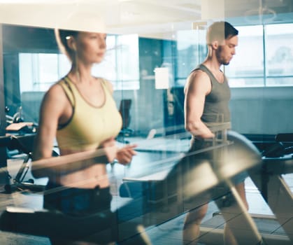 Young man and woman training on sports facilities in gym