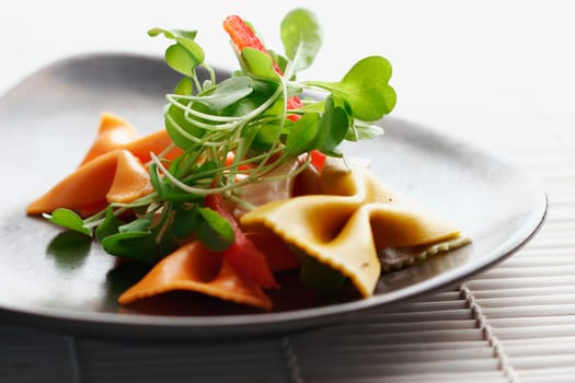 ribbon-shaped pasta with rocca and pepper