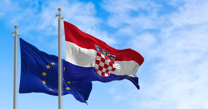 The flags of Croatia and the European Union flutter together on a clear day. Croatia has been a member of the eurozone since January 1, 2023. Realistic 3d illustration