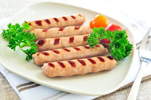 Serving of grilled breakfast sausages on a plate