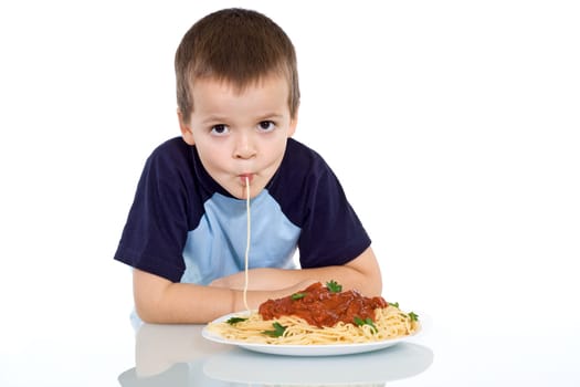 Boy eating pasta - sipping it up - isolated
