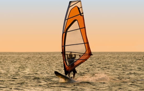 Silhouette of a windsurfer on the sea