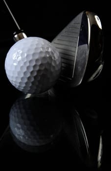 Golf club with ball in the black background