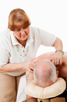 Massage therapist works on relieving tension in her client's shoulders.