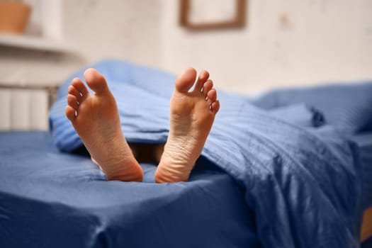 Soles of woman on the bed closeup
