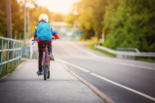Teenager in the morning hurrying on bicycle to the lesson. Concept of the back to school.