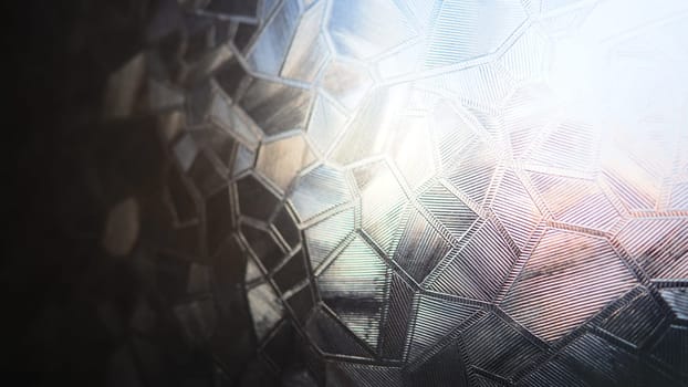 Fluted glass with backlight. Beautiful multicolored refraction of light. Abstract background. Self-adhesive film. Ribbed glass surface. Embossed glass background.