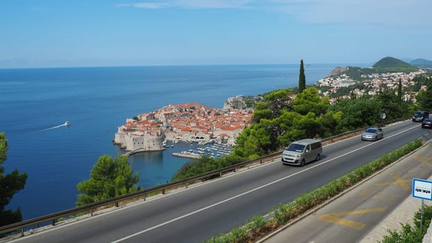Road traffic near Dubrovnik old town in Croatia. Dubrovnik Ragusa is a city in Croatia, the administrative center of the Dubrovnik-Neretva County. Top view from the observation deck on the rock
