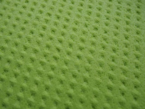 Sponge fibers sponge texture pattern surface close-up green yellow background.
